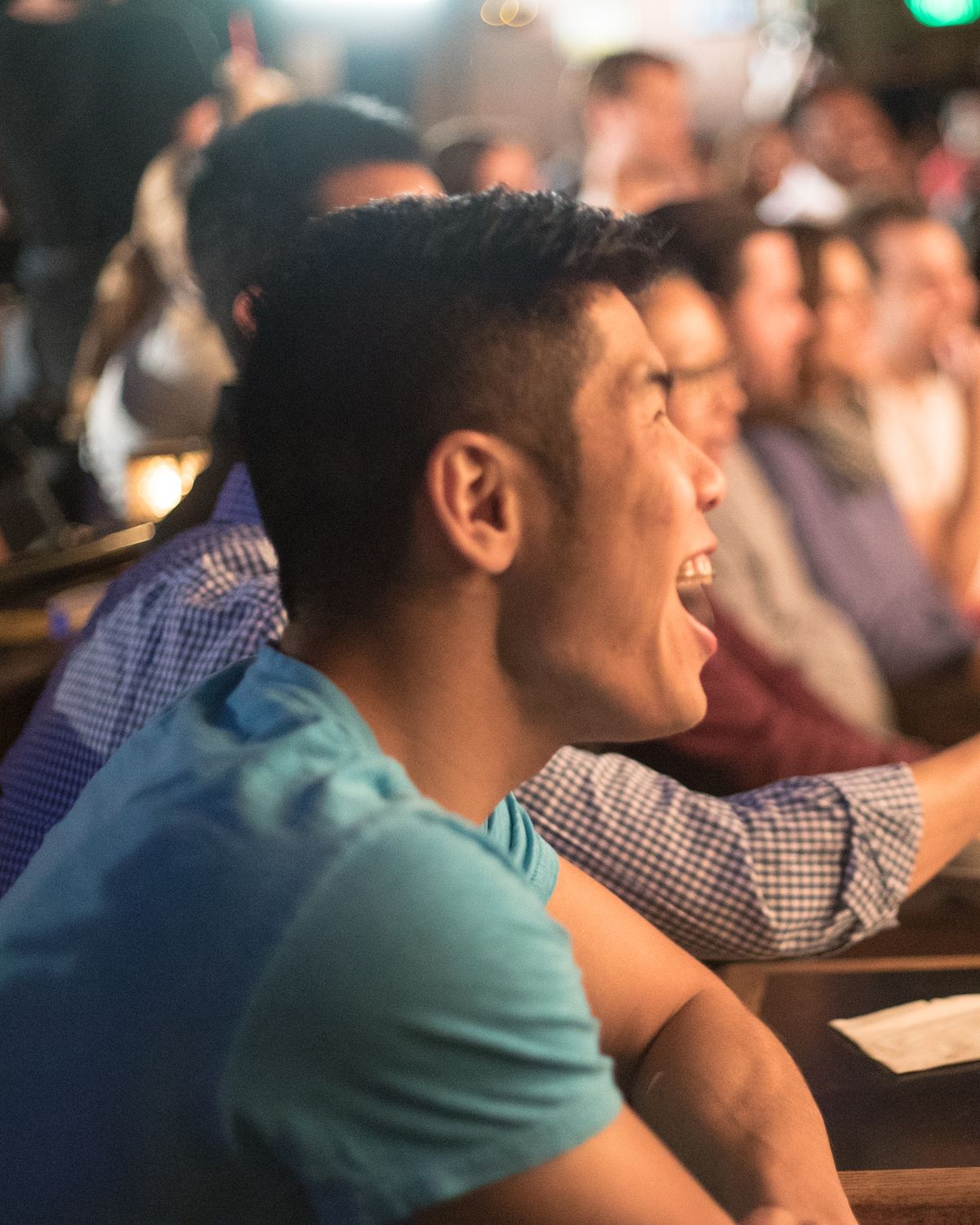 An audience member laughing hard at a Cool Beans Comedy show.