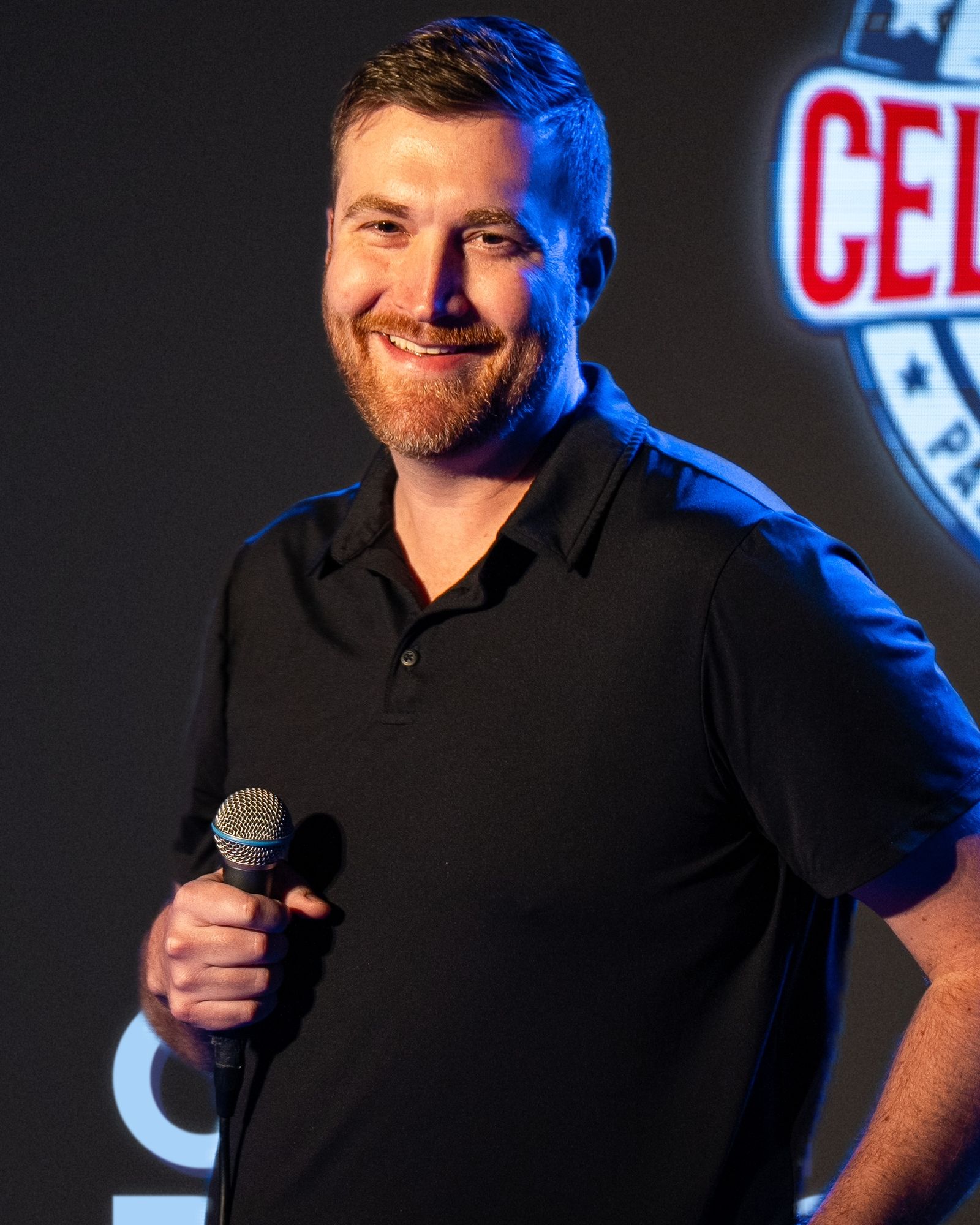 Ben Johnides smiling at the mic on the Ice House stage.
