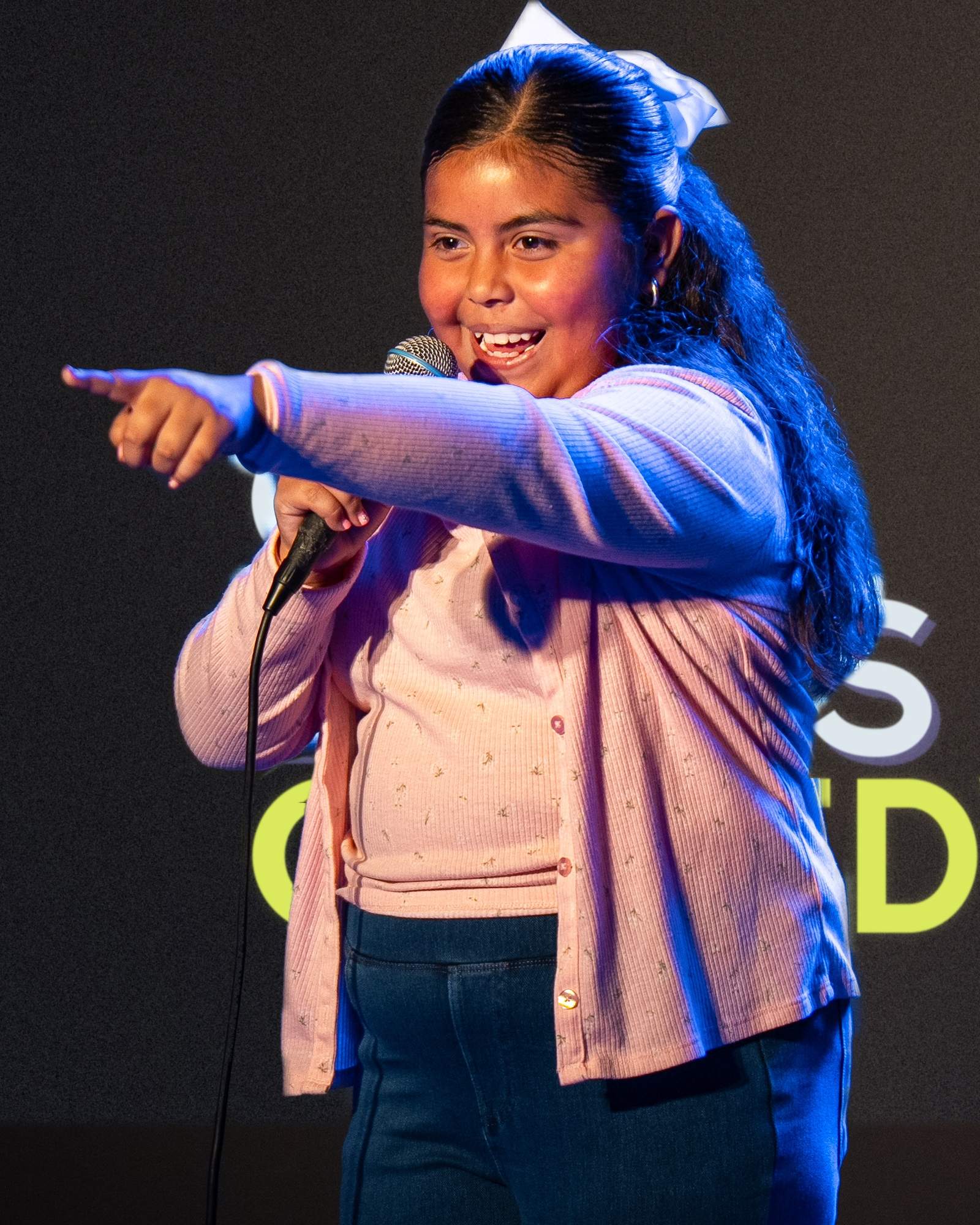 A young performer at the microphone on the Ice House stage.