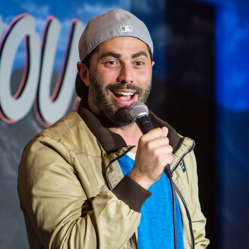 Adam Ray on stage at a Cool Beans Comedy show.