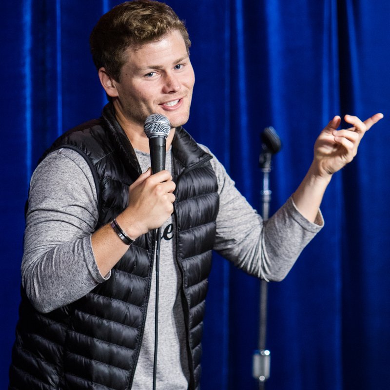 Drew Lynch on stage at a Cool Beans Comedy show.