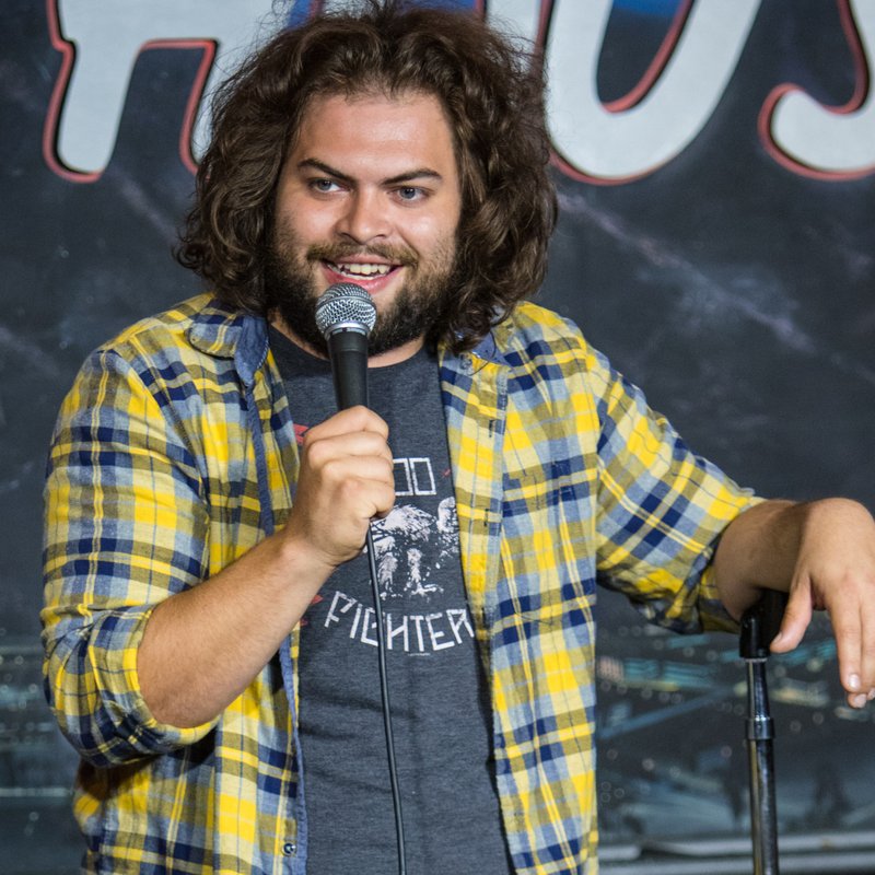 Dustin Ybarra on stage at a Cool Beans Comedy show.