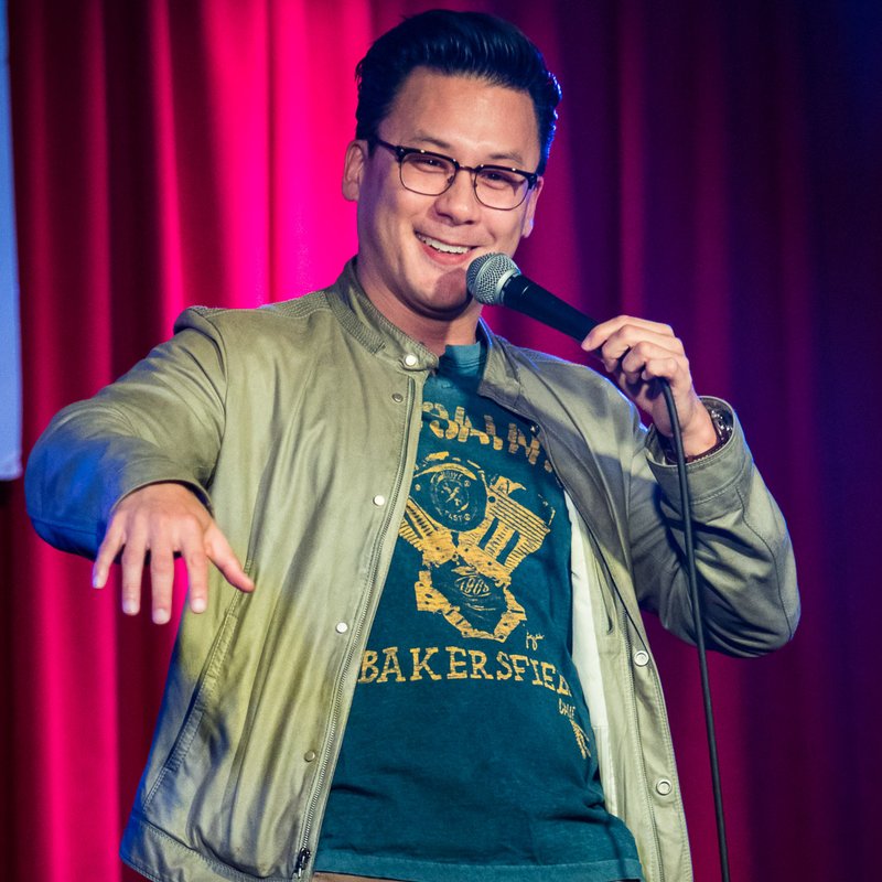 Eliot Chang on stage at a Cool Beans Comedy show.