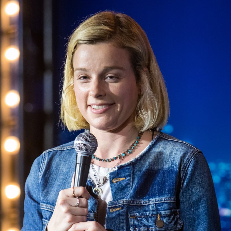 Erica Rhodes on stage at a Cool Beans Comedy show.