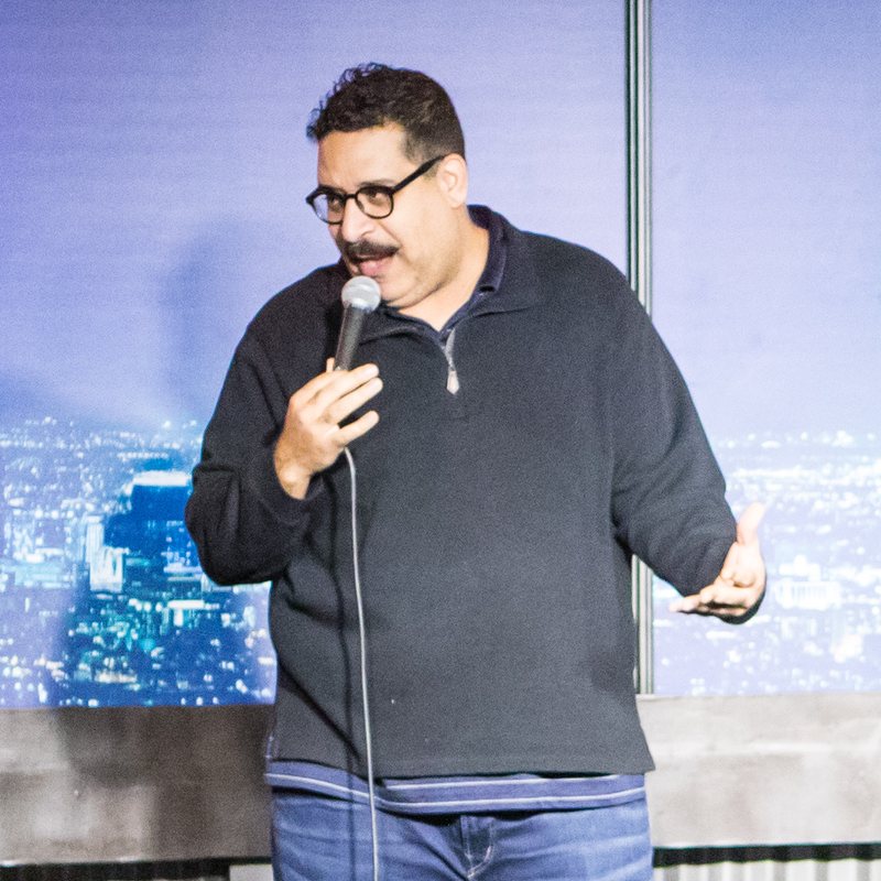 Erik Griffin on stage at a Cool Beans Comedy show.