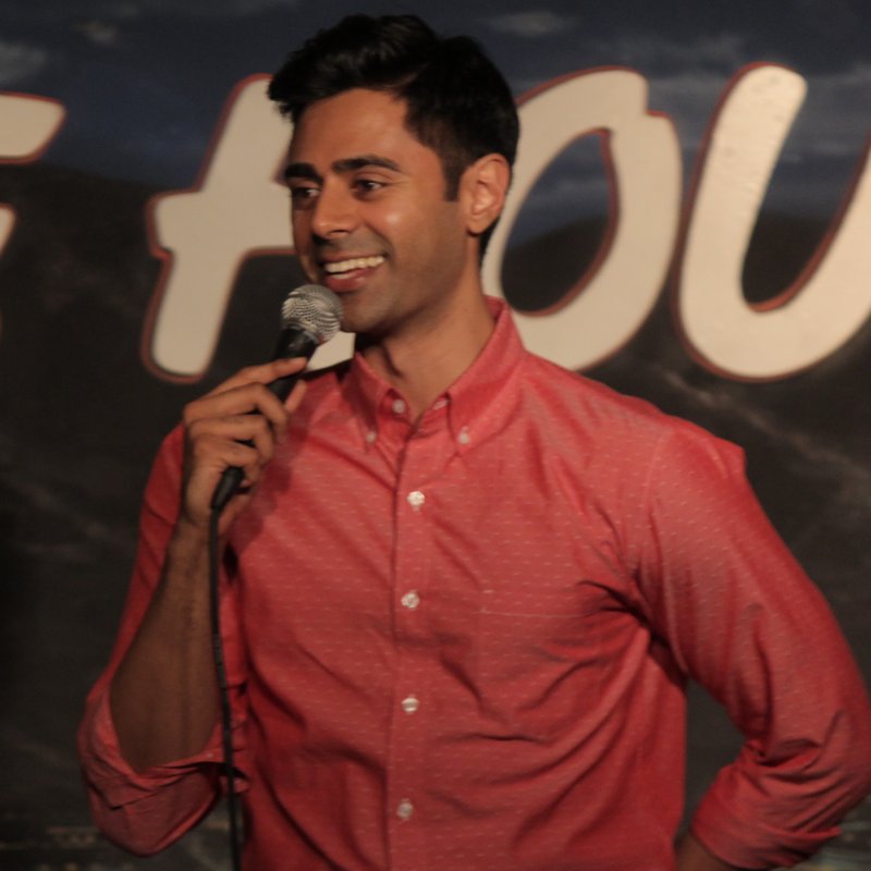Hasan Minhaj on stage at a Cool Beans Comedy show.