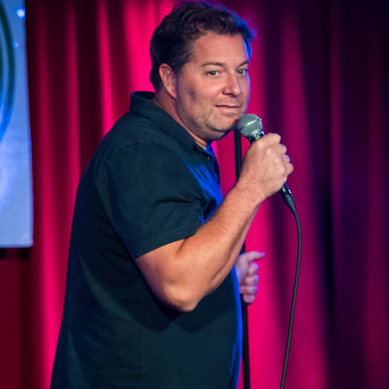 Jay Larson on stage at a Cool Beans Comedy show.