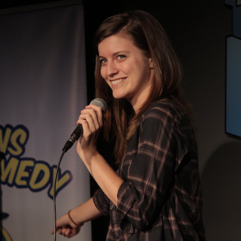 Jen D'Angelo on stage at a Cool Beans Comedy show.
