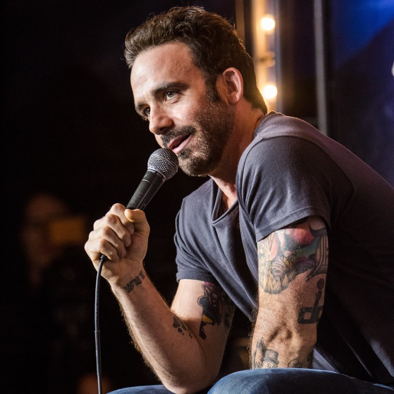 Josh Adam Meyers on stage at a Cool Beans Comedy show.