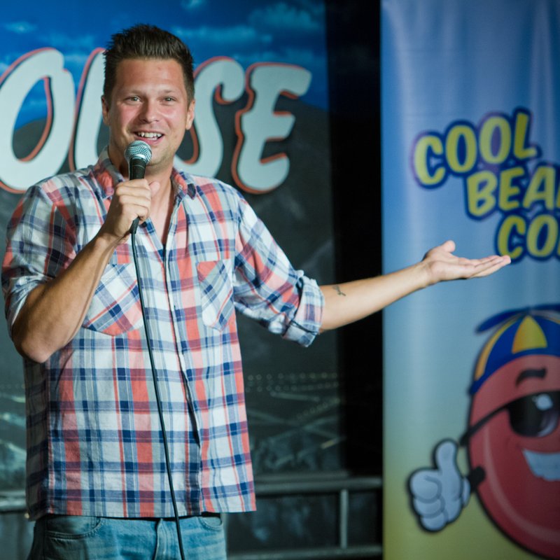 Julian McCullough on stage at a Cool Beans Comedy show.