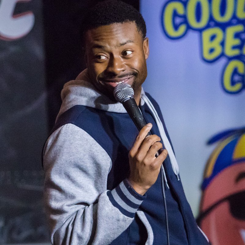 Justin Hires on stage at a Cool Beans Comedy show.