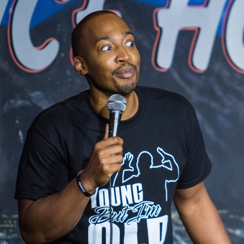 Keon Polee on stage at a Cool Beans Comedy show.