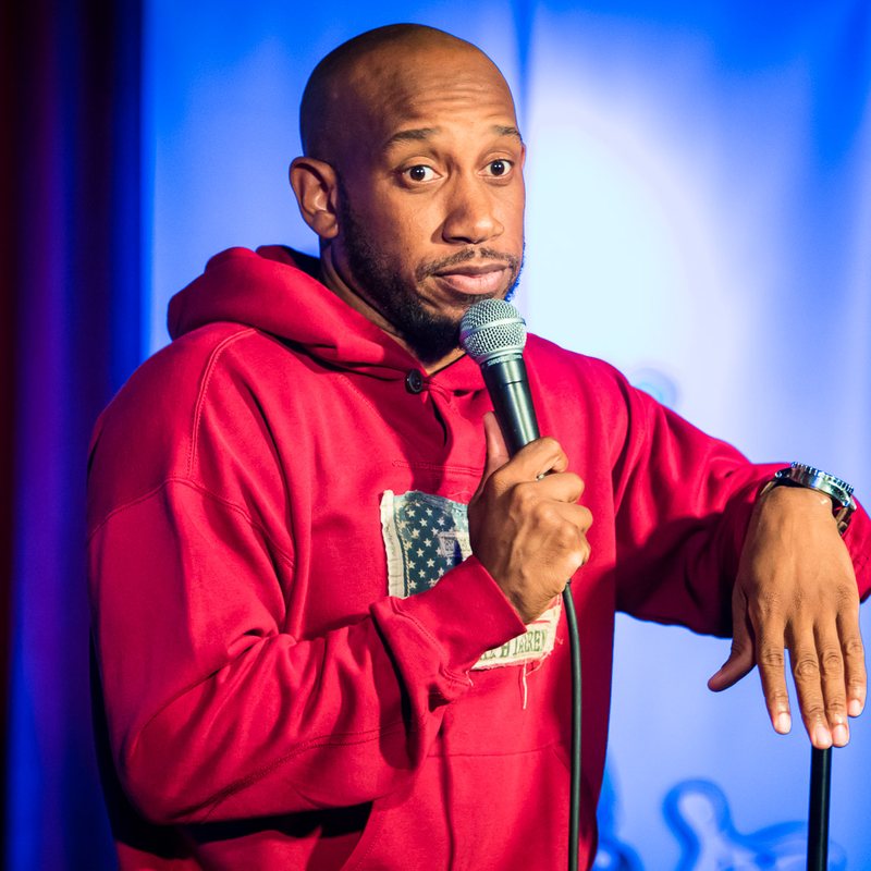 Malik S. on stage at a Cool Beans Comedy show.