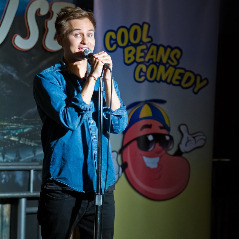 Moses Storm on stage at a Cool Beans Comedy show.