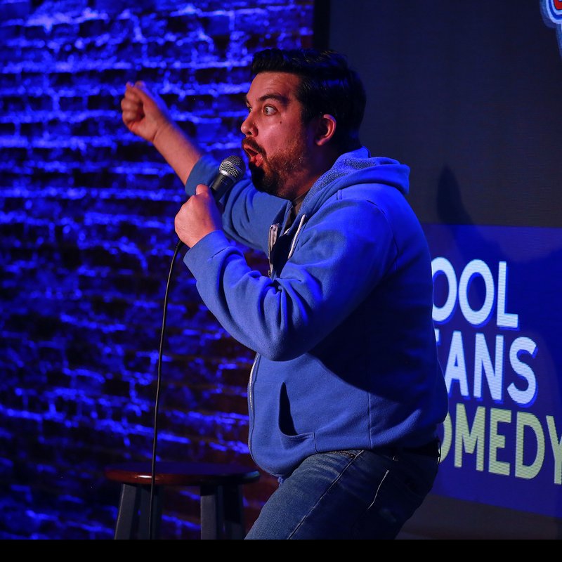 Piotr Michael on stage at a Cool Beans Comedy show.