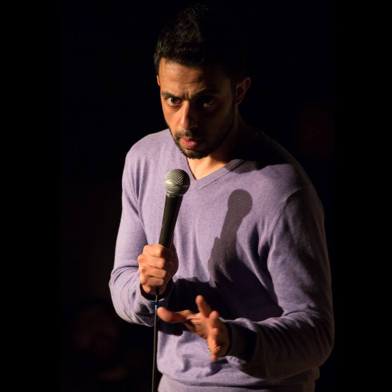 Sammy Obeid on stage at a Cool Beans Comedy show.