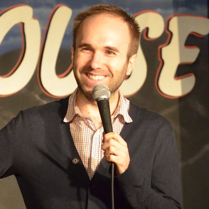 Taylor Williamson on stage at a Cool Beans Comedy show.