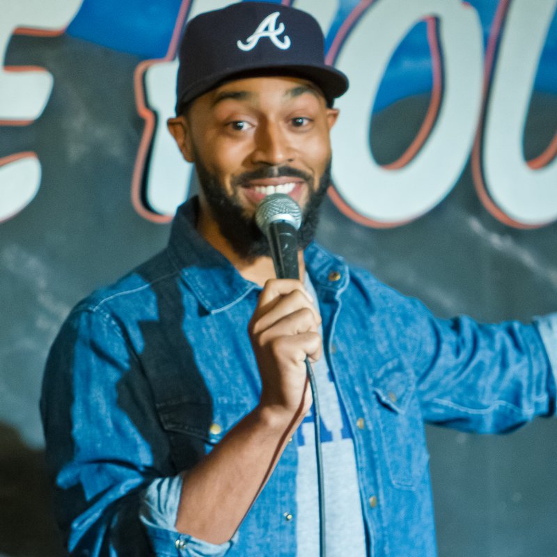 Tone Bell on stage at a Cool Beans Comedy show.