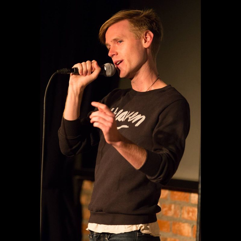 Zach Noe Towers on stage at a Cool Beans Comedy show.