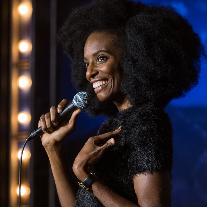 Zainab Johnson on stage at a Cool Beans Comedy show.