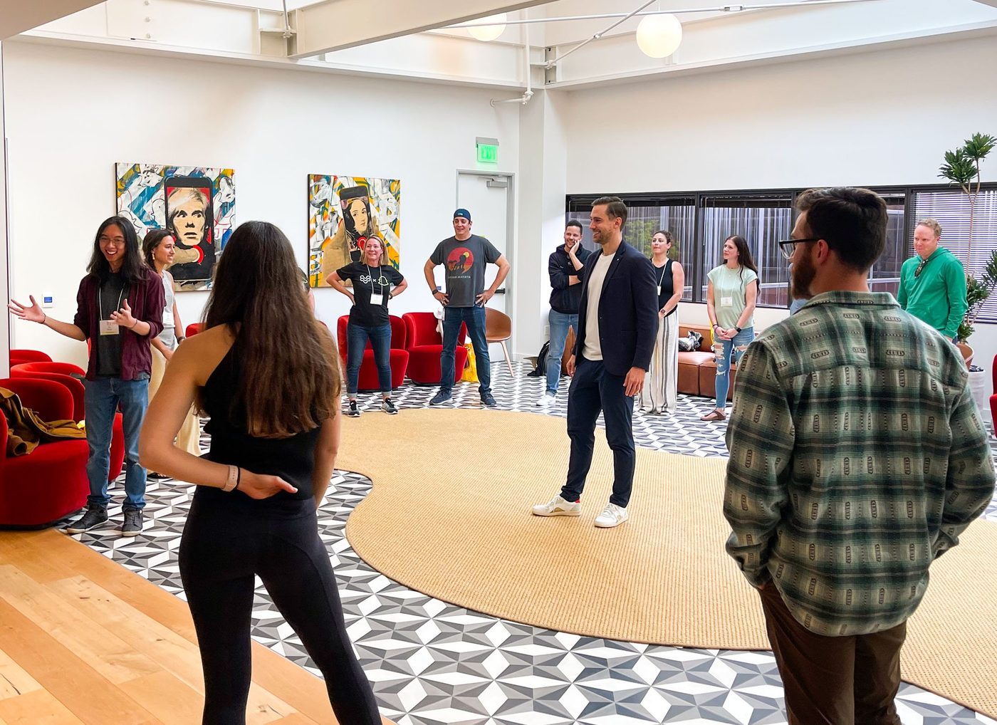 Corey Martin Craig leading a team through an improv exercise in their office.