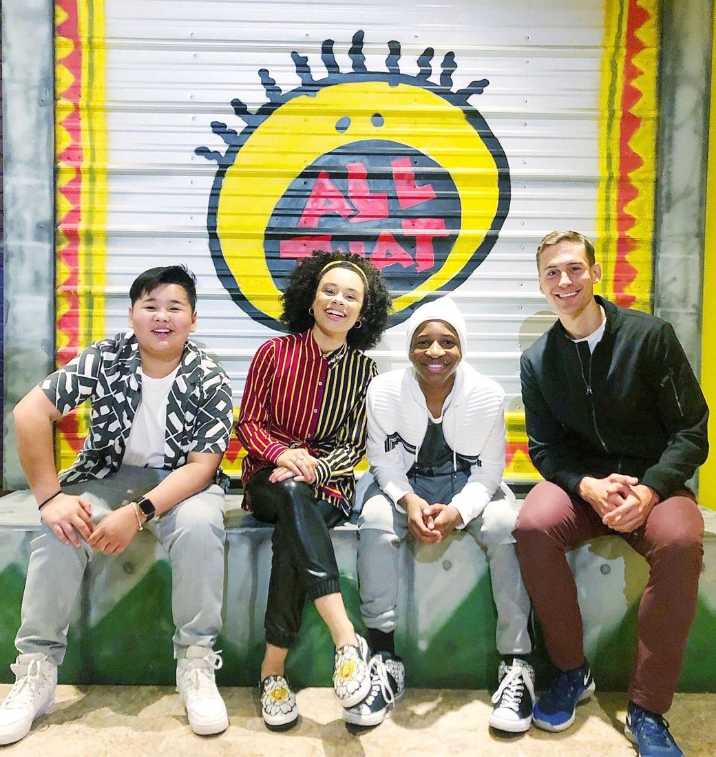 Corey Martin Craig with three Cool Beans grads in front of the Nickelodeon All That wall.